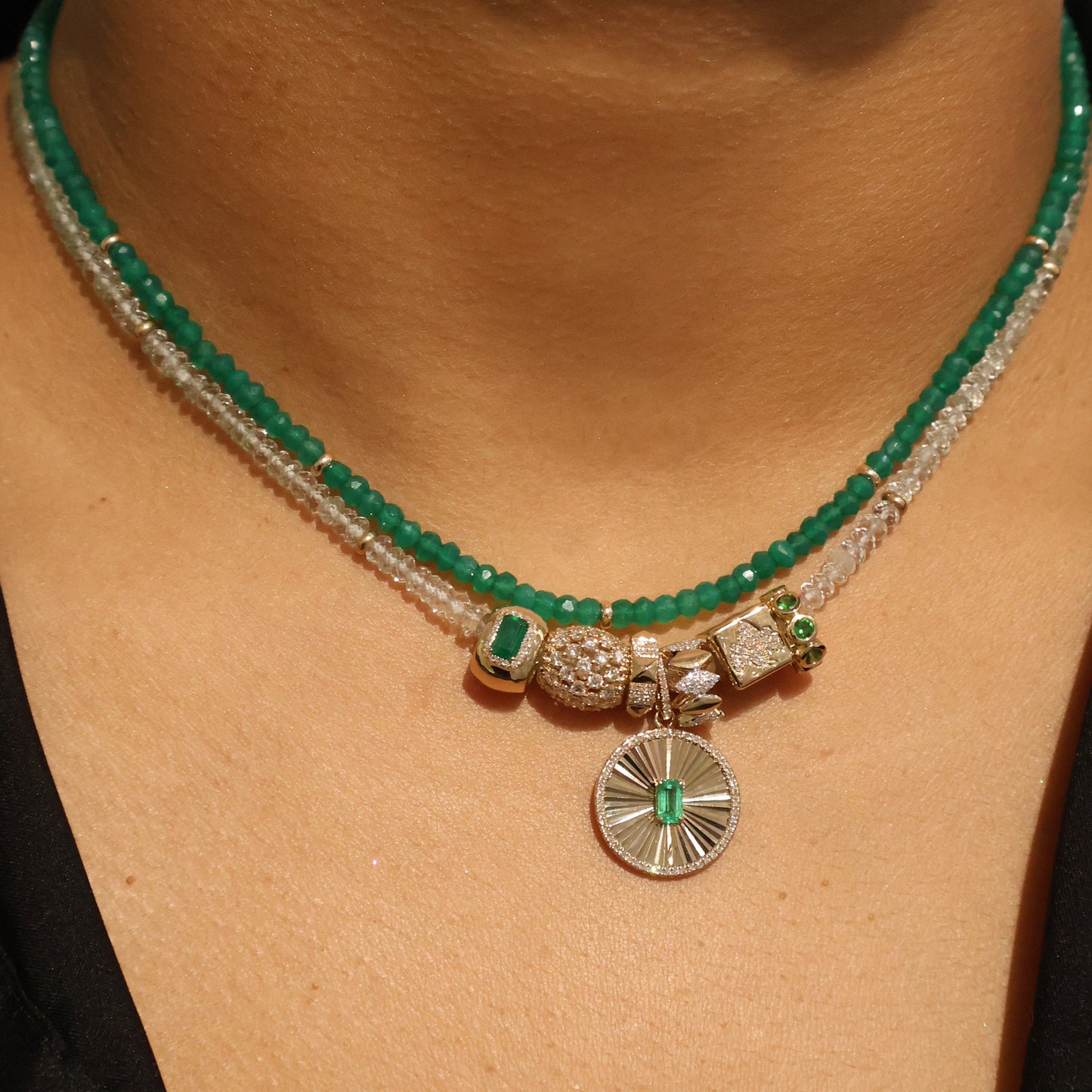 Necklace with green beads and decorative elements on a person's neck